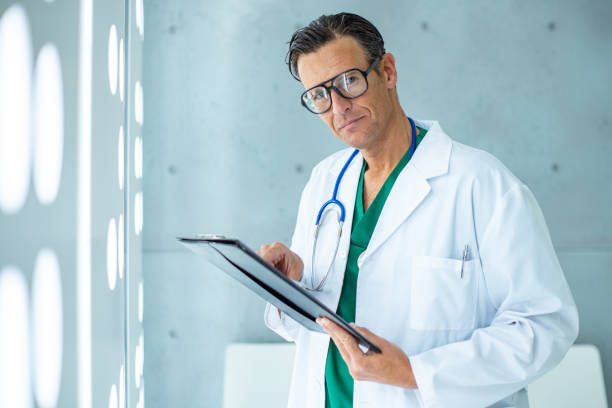 istock Doctor in lab coat analyzing medical report 1217946173