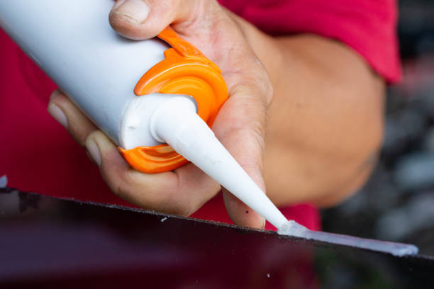 istock Craftsmen are using silicone adhesives for general and industrial applications. 1217947606
