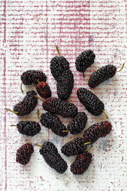 istock delicious and healthy mulberries on pink table 1217949127