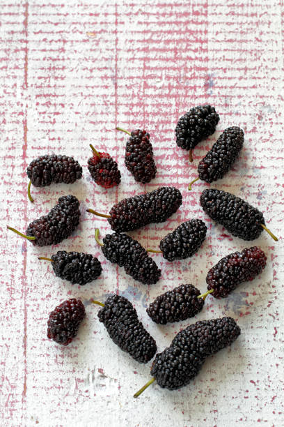 istock delicious and healthy mulberries on pink table 1217949157