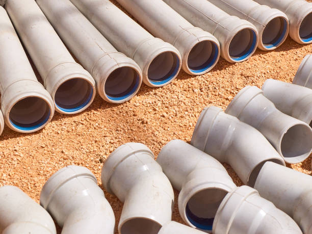Plastic parts of sewage pipeline system at construction site Plastic parts of sewage pipeline system at construction site. pvc conduit stock pictures, royalty-free photos & images