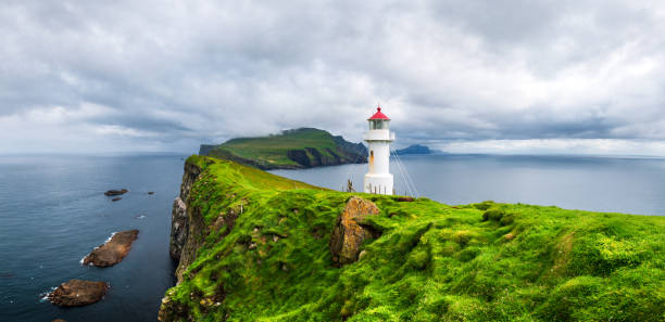 Panoramic view of old lighthouse on the Mykines island Panoramic view of old lighthouse on the Mykines island, Faroe islands, Denmark. Landscape photography mykines faroe islands photos stock pictures, royalty-free photos & images