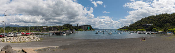 Bathing beach and boats in the harbor on Villarrica lake in Pucon, Chile stock photo
