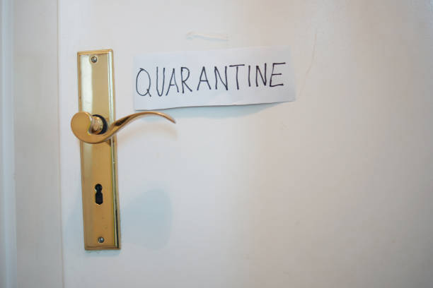 istock COVID-19 Coronavirus concept, closed door with handle and note quarantine. 1217952257
