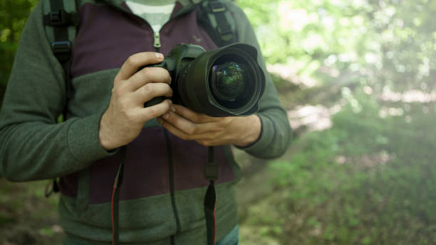 istock photographer holds the camera in his hands 1217953007