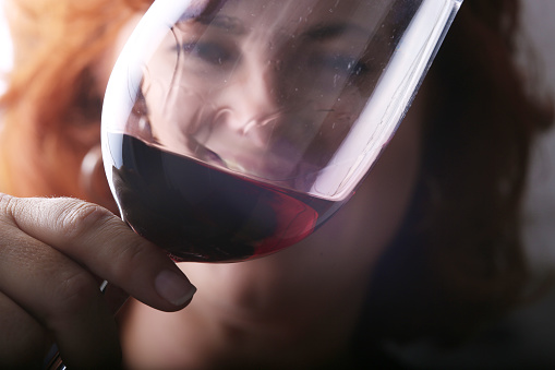 Close-up of a woman drinking red wine