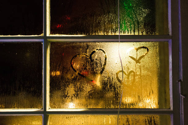 istock Hand-painted heart shape on fogged window pane 1217956136
