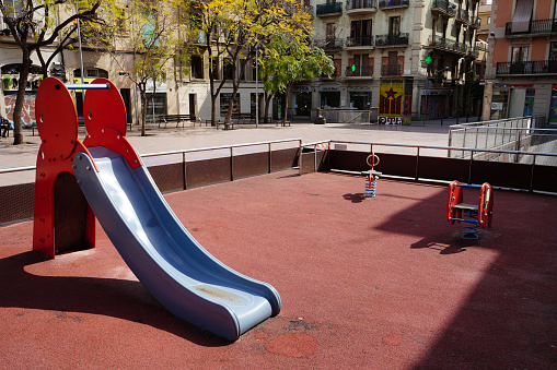 Deserted children´s playground in Placa de la Revolucio - Gracia neighborhood, during Covid-19 lockdown