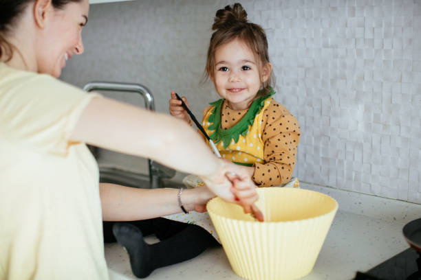 istock Mother and daughter baking stock 1217958774