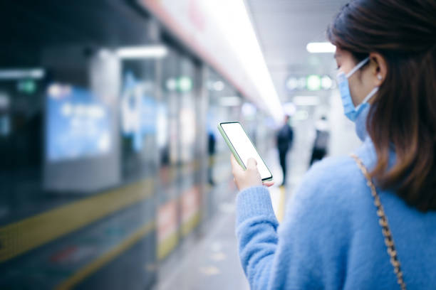 istock A young woman using smart phone in subway station. 1217959423
