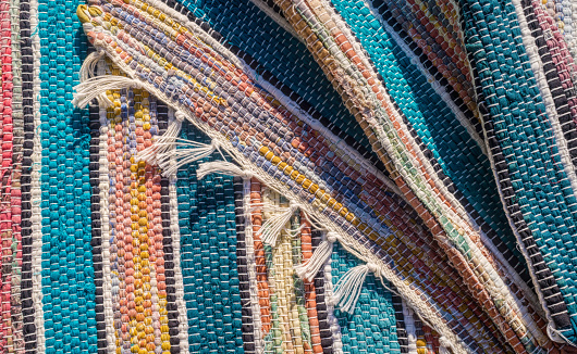 Striped rough multi-colored homespun fabric. Colorful canvas, an example of folk art and needlework. Vintage background