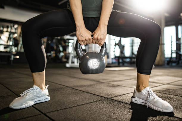 istock Unrecognizable female athlete exercising with kettle bell in a gym. 1217961252
