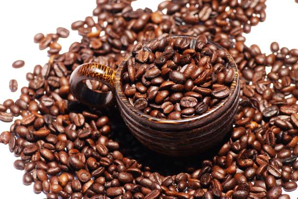 istock Wooden  cup and coffee  bean on  isolate white background  , selective focus . 1217961309