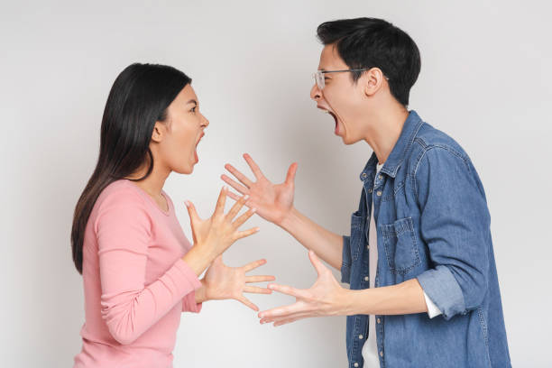 istock Asian man and woman fighting over grey background 1217962280