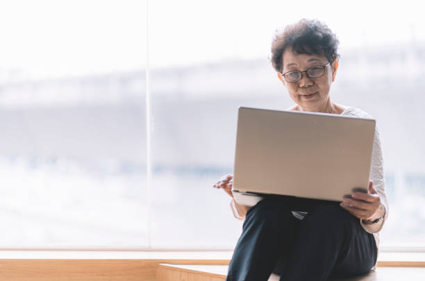 istock asian chinese senior woman using compuiter for working in office 1217962389