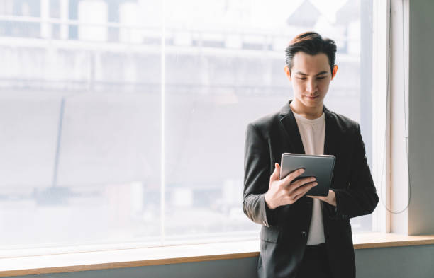 istock young asian chinese businessman using tablet 1217962495