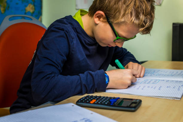 istock teenager doing homework in his room 1217962645
