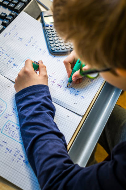 istock teenager doing homework in his room 1217962718