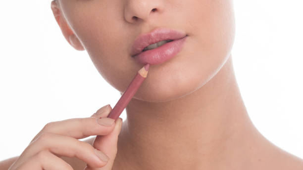 istock Unrecognizable woman applying nude lip liner in studio 1217962785