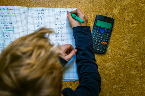 istock teenager doing homework laying on floor 1217963556