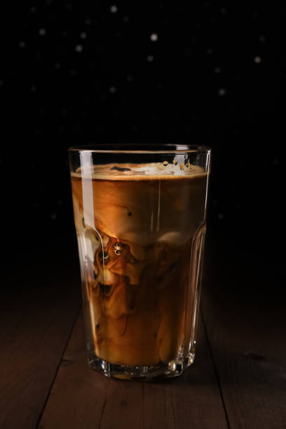 istock Ice latte coffee in tall glass on wooden table. 1217964105