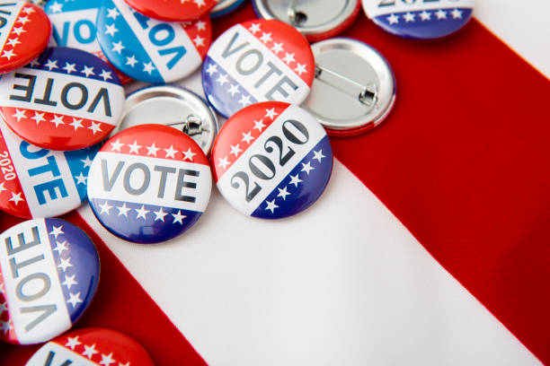 American vote badges on national USA flag background American vote badges on national USA flag background, copy space, elections 2020 democratic party usa photos stock pictures, royalty-free photos & images