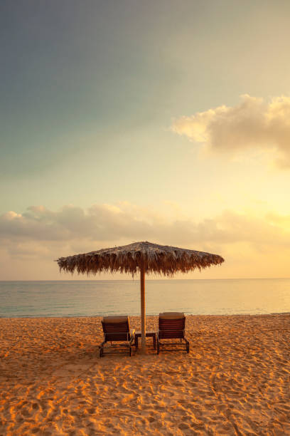 istock two sun chairs and an umbrella, oman 1217965715