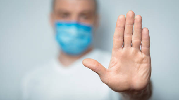 istock Unrecognizable Man In Medical Mask Gesturing Stop In Studio, Panorama 1217965787