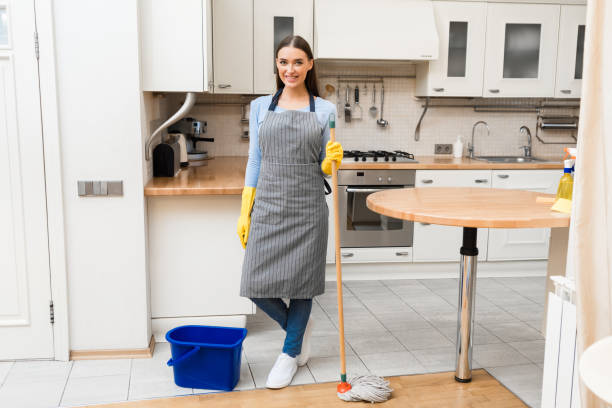 istock Young woman holding mop to clean floor 1217966496