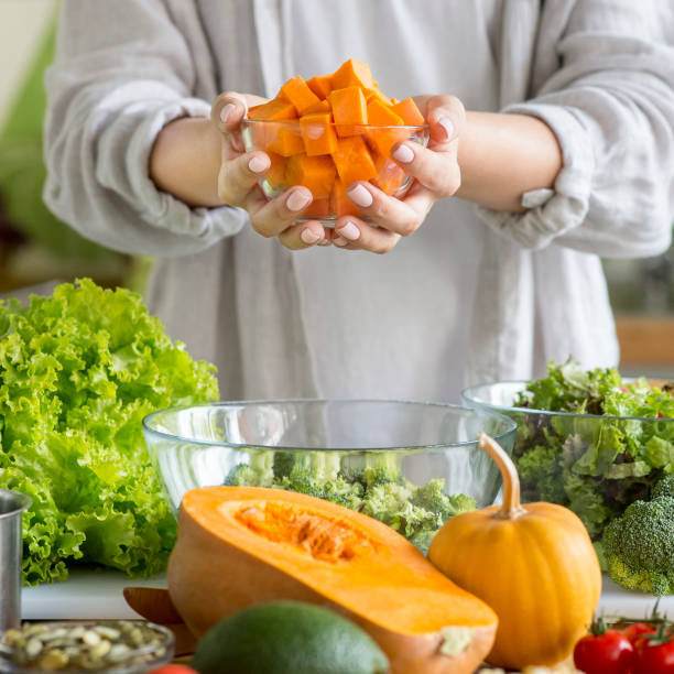 istock Unrecognizable girl enjoying vegetable salad with pumpkin 1217968122