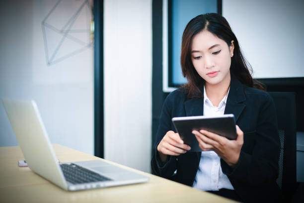 istock Asian business women using tablet  for working at office relax time and smiling 1217971132