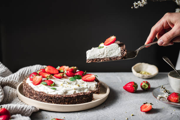 istock Woman taking a portion of a yogurt strawberry pie 1217972769