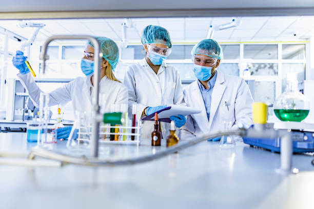 istock Team of scientists working on scientific research in laboratory. 1217973505