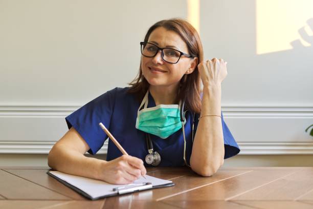 istock Female doctor looking at webcam, video conference 1217973939