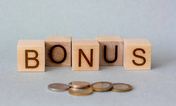 istock money and bonus on a wooden cube 1217974973