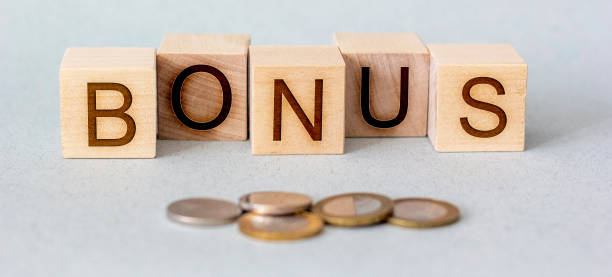 istock money and bonus on a wooden cube 1217974977