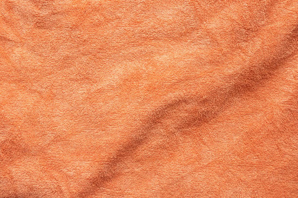 istock Orange towel fabric texture surface close up background 1217975165