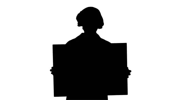 Photo of Silhouette Woman doctor in a mask holding an empty board