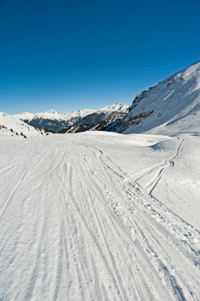 istock View down a piste in alpine ski resort 1217977688