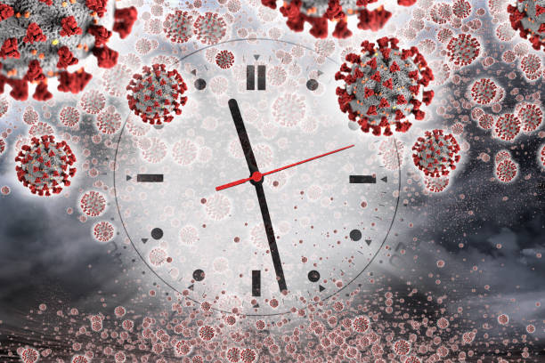 istock Global epidemic concept of viruses and clock face 1217978189