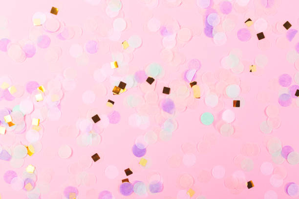 istock Falling colorful confetti on pink background. 1217980911