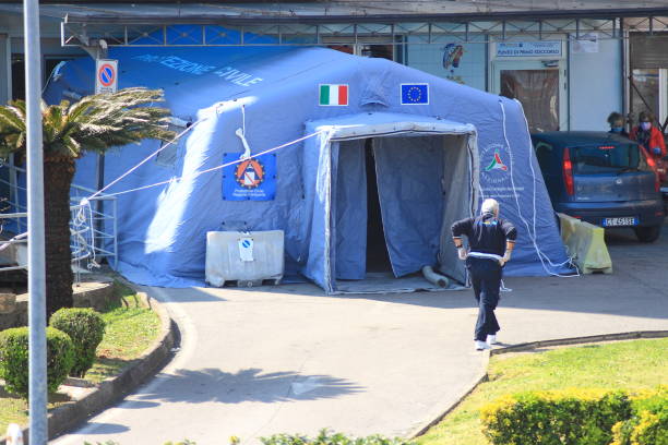 Tent used as a first reception for the sick from covid-19 Pagani,Sa,Italy - April 10,2020 :A Civil Protection tent used as pre-triage for suspected patients from Covid-19 located outside the Emergency Department of the Andrea Tortora Civil Hospital in Pagani triage stock pictures, royalty-free photos & images