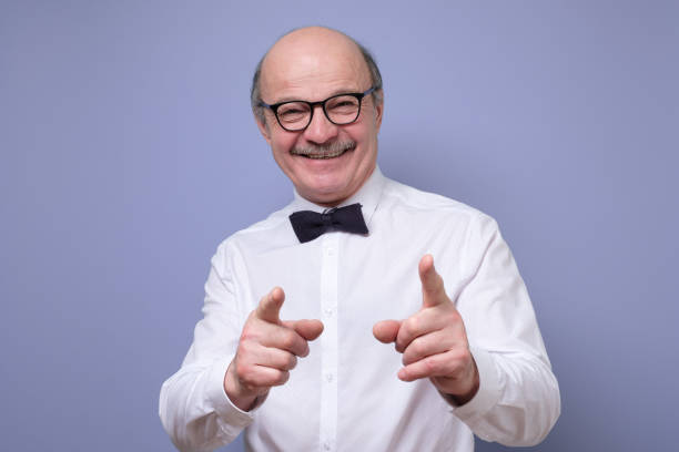 istock Handsome mature man in glasses pointing at camera pointing at you 1217981648
