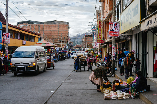 Huaraz, Peru, July 28, 2014: daily life hustle in andean city street with food vendors and vehicles, in election period