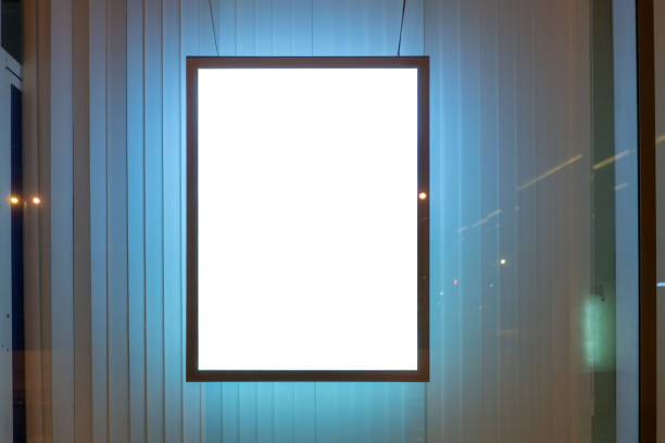 istock advertising billboard in window and the curtains behind at night glowing 1217982630