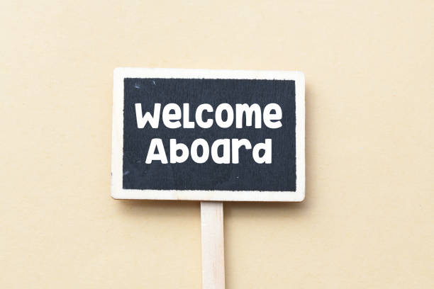 WELCOME ABOARD. The word welcome aboard written on a chalk board.