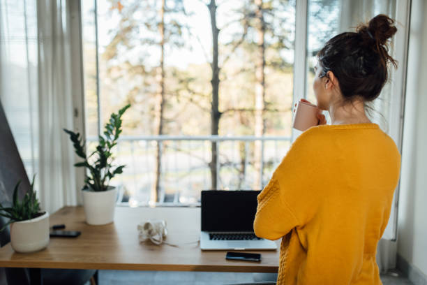 istock Young freelancer taking a coffee break at her home office 1217984907