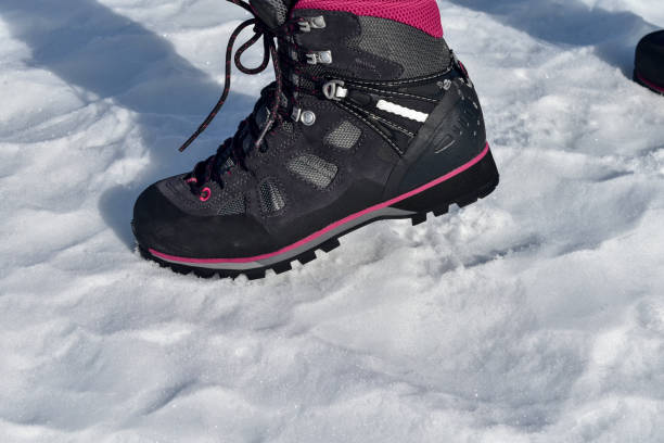 istock Winter hiking boots on snow. 1217985838