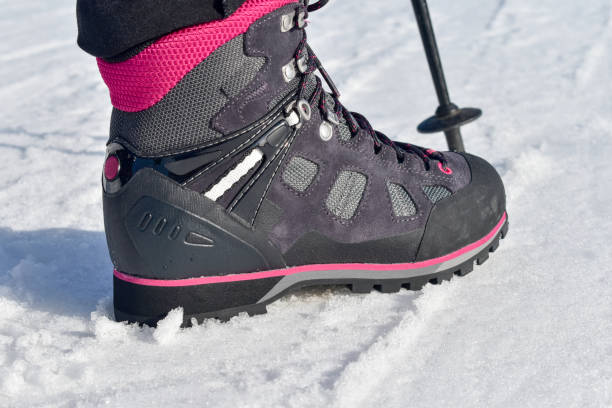 istock Winter hiking boots on snow. 1217985897