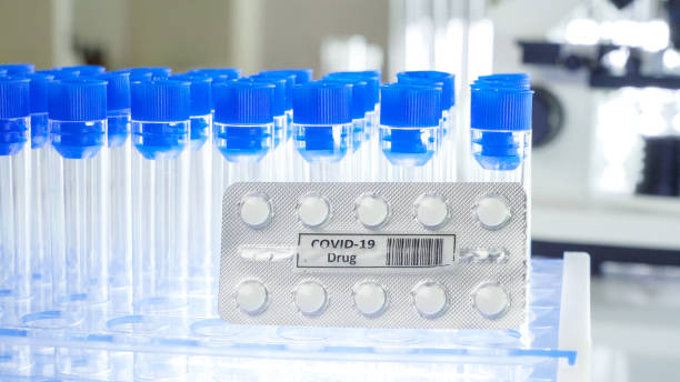 istock Blue cap empty test tubes with the coronavirus pills 1217986357